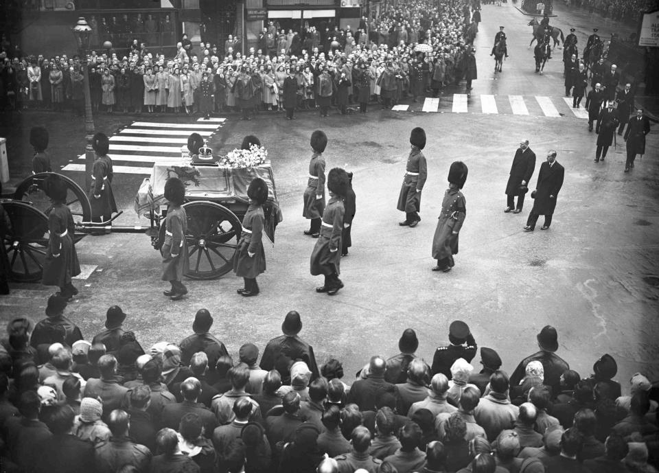 FILE - Slowly the cortege of late King George VI turns from Kingsway into Aldwych, in London, on Feb. 11, 1952, en route to Westminster Hall. Hundreds of thousands of people are expected to flock to London’s medieval Westminster Hall from Wednesday, Sept. 14, 2022, to pay their respects to Queen Elizabeth II, whose coffin will lie in state for four days until her funeral on Monday. (AP Photo/Rider)