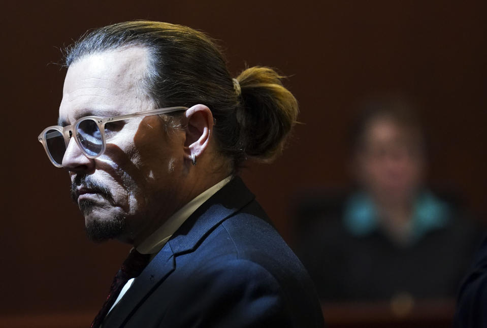 Actor Johnny Depp gets up during a break in the courtroom at the Fairfax County Circuit Courthouse in Fairfax, Va., Wednesday, May 18, 2022. Actor Johnny Depp sued his ex-wife Amber Heard for libel in Fairfax County Circuit Court after she wrote an op-ed piece in The Washington Post in 2018 referring to herself as a "public figure representing domestic abuse." (Kevin Lamarque/Pool Photo via AP)