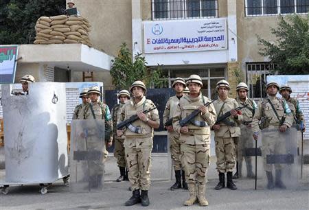 Egyptian soldiers stand guard in the courtyard of a school that will be used as a polling station in Suez January 13, 2014. REUTERS/Al Youm Al Saabi Newspaper