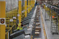 FILE PHOTO: Amazon packages are pushed onto ramps leading to delivery trucks by a robotic system as they travel on conveyor belts inside of an Amazon fulfillment center on Cyber Monday in Robbinsville, New Jersey