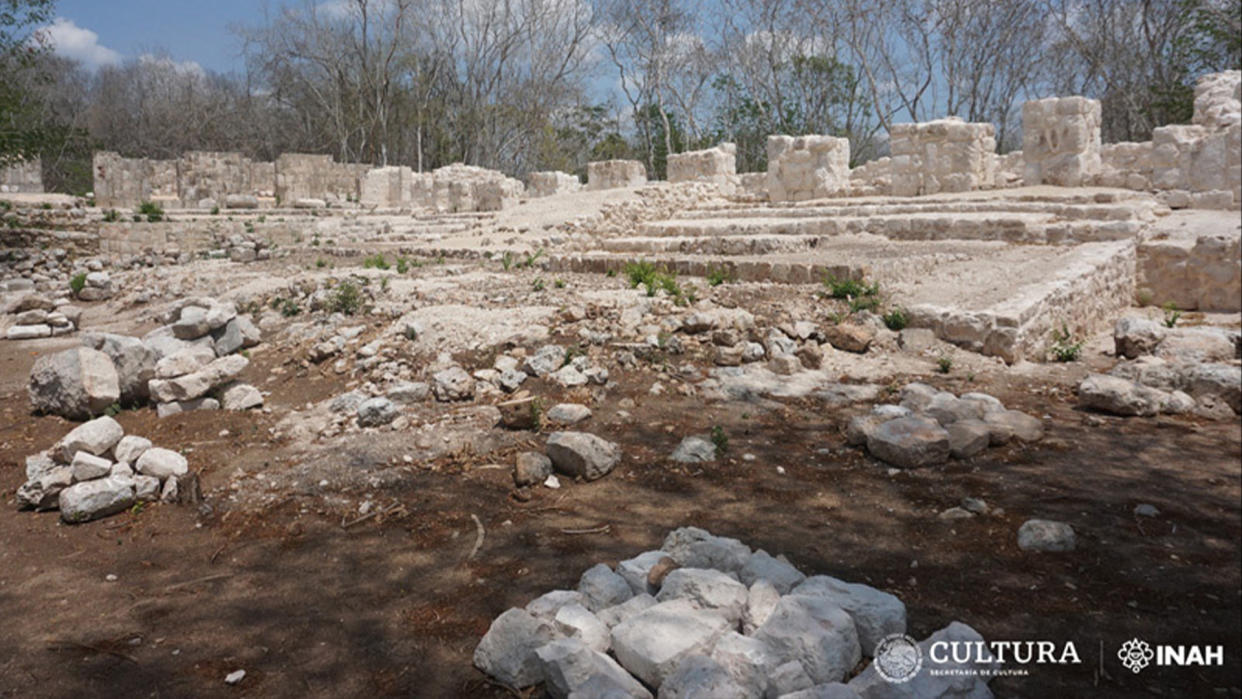  The foreground of an unearthed palace-like Mayan building. 