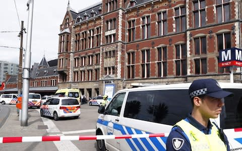 Security official stands guard outside Amsterdam's main railway station. - Credit: Remko De Waal/AFP