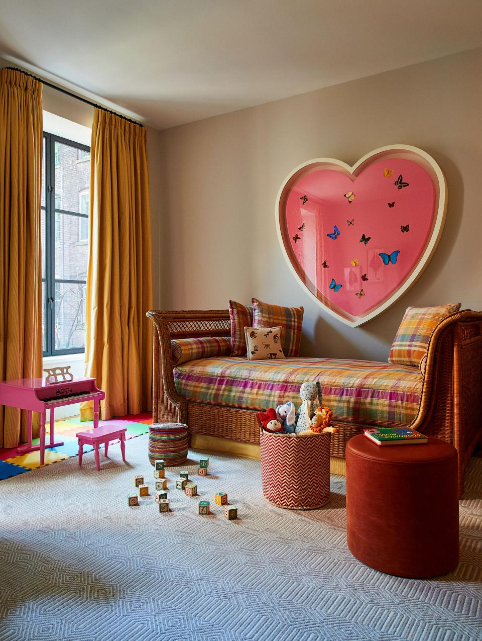 In the girls’ bedroom, a Grange daybed is upholstered in an Etro fabric; Damien Hirst artwork, Afghan carpet.