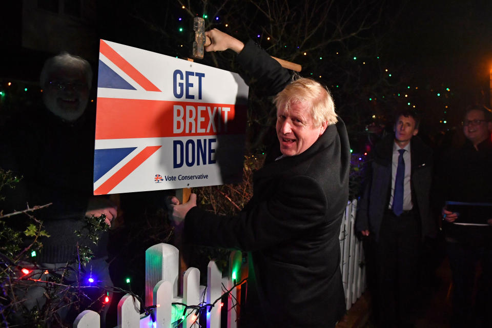 Britain's Prime Minister and Conservative party leader Boris Johnson poses with a sledgehammer, after hammering a "Get Brexit Done" sign into the garden of a supporter, in South Benfleet, Britain December 11, 2019. Ben Stansall/Pool via REUTERS