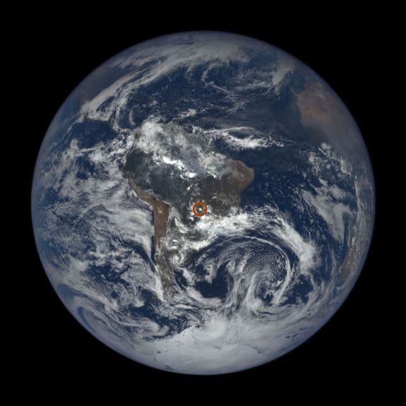 A full view of the Earth with sun glint.