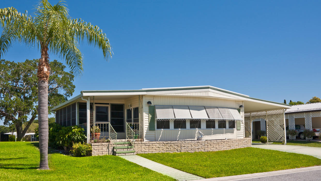 manufactured home next to palm tree