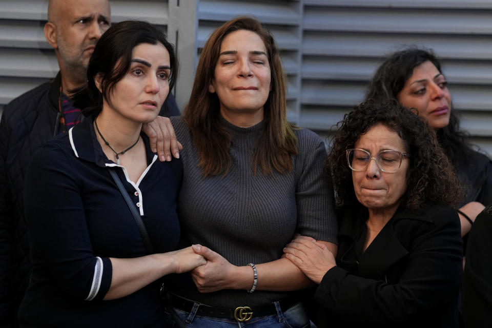 Colleagues of the two slain journalists of pan-Arab TV network Al-Mayadeen, who were killed by an Israeli strike, mourn outside the station's headquarters in Beirut, Lebanon, Tuesday, Nov. 21, 2023. An Israeli strike on southern Lebanon killed Tuesday two journalists reporting for the Beirut-based Al-Mayadeen TV on the violence along the border with Israel, according to the Lebanese information minister and their TV station. (AP Photo/Bilal Hussein)