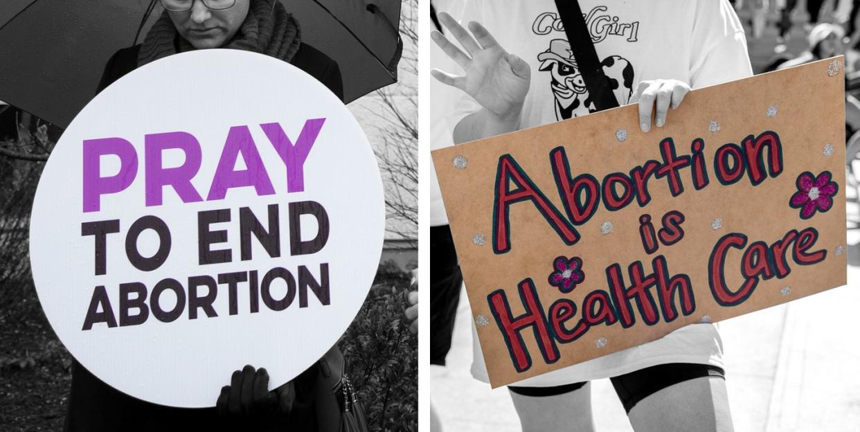 one protest sign on the left that reads pray to end abortion and one on the right that reads abortion is health care