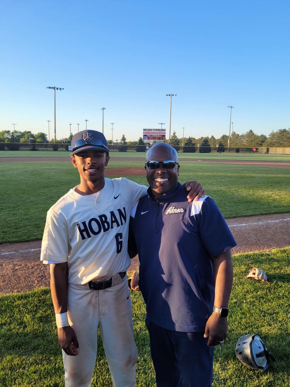 Archbishop Hoban sophomore Masud Jennings, left, and his father, Markus Jennings, right, smile after the Knights won a Division II baseball regional championship. Markus Jennings is a 1988 Buchtel High School graduate who helped the Griffins win a Division II football state championship in 1987.
