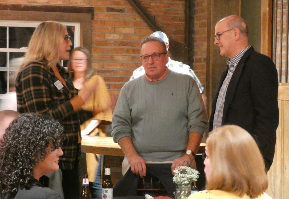 Bucyrus Mayor Jeff Reser, right, chats with Erin Stine of the Crawford Partnership and Randy Fischer, center, during the Bucyrus Area Chamber of Commerce's annual dinner on Thursday evening at the Loft at Pickwick Place.