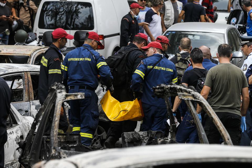 <p>A woman reacts as she stands amid the charred remains of burned-out cars in Mati east of Athens, Tuesday, July 24, 2018. (Photo: Thanassis Stavrakis/AP) </p>