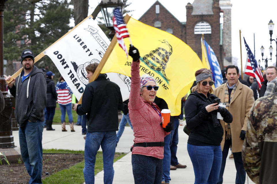 Protesters attend a rally outside the State Capitol in Lansing, Mich., Wednesday, April 15, 2020.  (AP Photo/Paul Sancya)