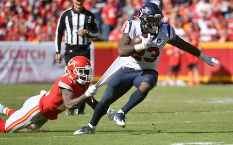 Houston Texans running back Carlos Hyde (23) runs the ball as Kansas City Chiefs defensive back Bashaud Breeland (21) attempts the tackle during the second half at Arrowhead Stadium - Credit: USA Today