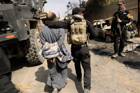 Iraqi Special Operations Forces detain a person suspected of belonging to Islamic State militants in western Mosul March 8, 2017. REUTERS/Zohra Bensemra