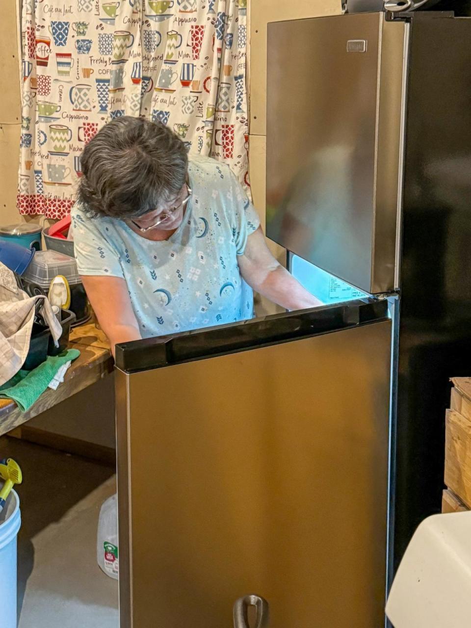 PHOTO: Eleanor Paddock looks inside her refrigerator, newly connected to electricity by Navajo Power in Navajo Nation.  (Dan Manzo/ABC News)