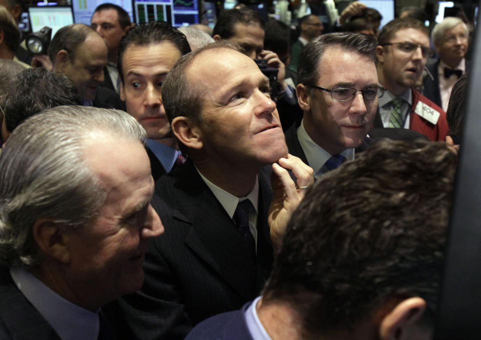 FILE - Then-Nielsen Company CEO David Calhoun, center, watches progress as he waits for the company's IPO to begin trading, Jan. 26, 2011, on the floor of the New York Stock Exchange. National Transportation Safety Board Chair Jennifer Homendy, the nation’s chief accident investigator, said Wednesday, March 13, 2024, that her agency still doesn’t know who worked on the panel that blew off a jetliner in January and that Boeing’s David CEO Calhoun told her that he couldn’t provide the information because the company has no records about the job. (AP Photo/Richard Drew, File)