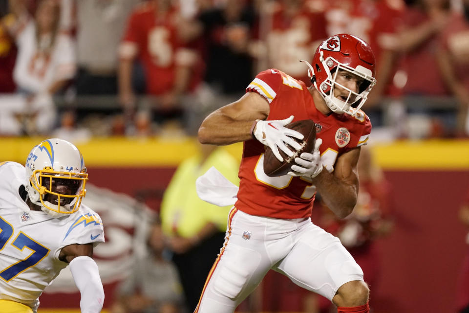 Kansas City Chiefs wide receiver Justin Watson catches a pass for a touchdown as Los Angeles Chargers cornerback J.C. Jackson (27) defends during the second half of an NFL football game Thursday, Sept. 15, 2022, in Kansas City, Mo. (AP Photo/Charlie Riedel)