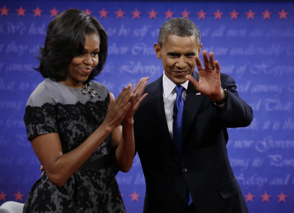 President Barack Obama and Michelle wave to members of the audience following the third presidential debate with Republican presidential nominee Mitt Romney at Lynn University, Monday, Oct. 22, 2012, in Boca Raton, Fla. (AP Photo/David Goldman)