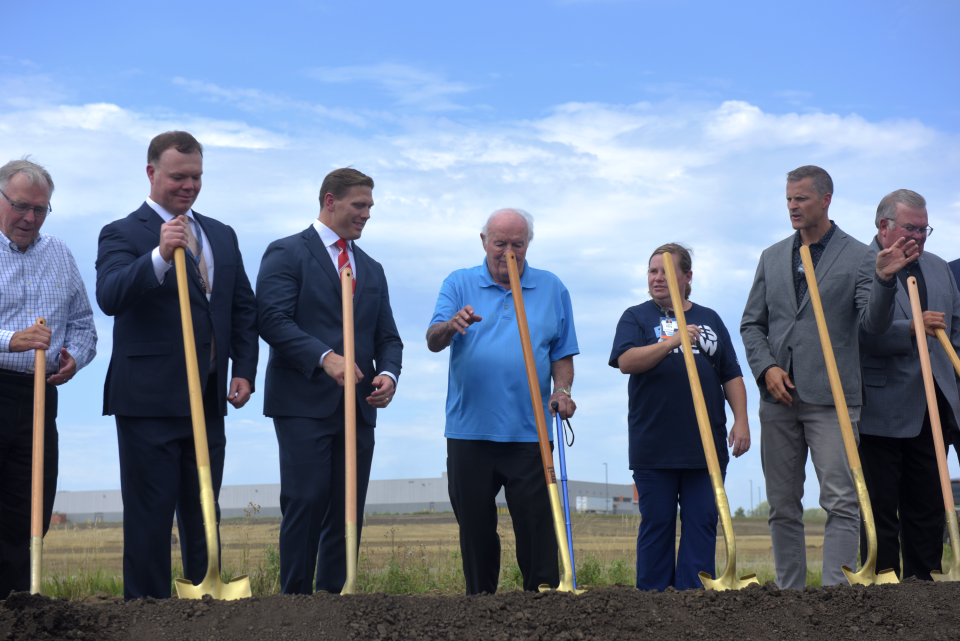 T. Denny Sanford (center) reaches for a shovel during the groundbreaking ceremony for Sanford Health's Virtual Care Center Tuesday, Aug. 23, 2022. He was praised by Sanford Health CEO and president Bill Gassen (center-left) during the ceremony for his $350 million donation to the virtual care initiative alongside nurses and physicians for their role as the frontline workers during the pandemic.