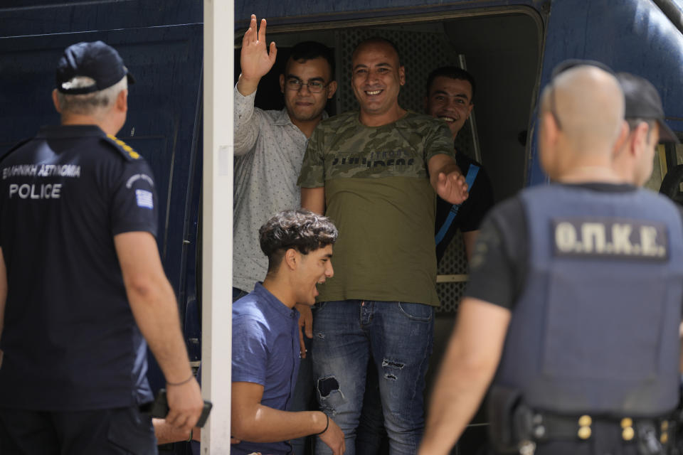 Four of nine Egyptians, who were on trial for migrant smuggling, react as they leave from the court in Kalamata, southwestern Greece, on Tuesday, May 21, 2024. A Greek judge dismissed charges against nine Egyptian men accused of causing a shipwreck that killed hundreds of migrants last year and sent shockwaves through the European Union's border protection and asylum operations, after a prosecutor told the court Greece lacked jurisdiction. (AP Photo/Thanassis Stavrakis)