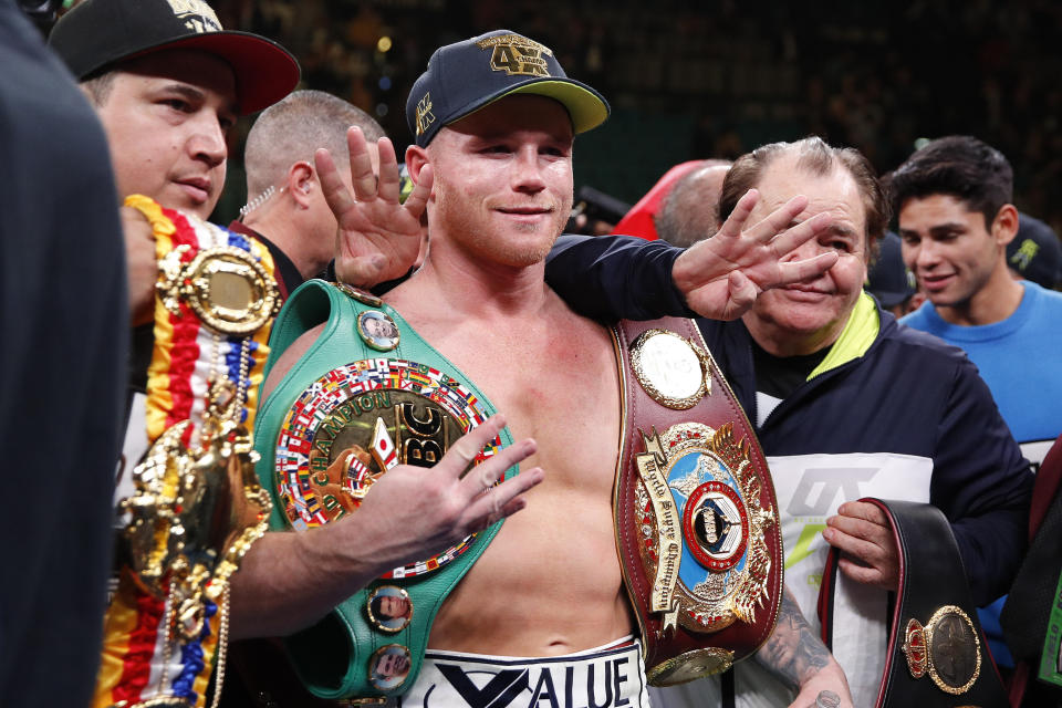 Canelo Alvarez poses for photos after defeating Sergey Kovalev by knockout.