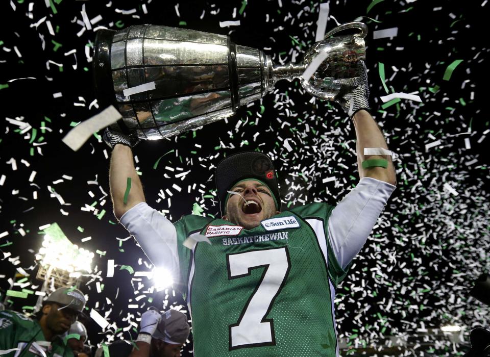 Saskatchewan Roughriders Weston Dressler hoists the Grey Cup after his team defeated the Hamilton Tiger Cats to win the CFL's 101st Grey Cup championship football game in Regina, Saskatchewan November 24, 2013. REUTERS/Todd Korol (CANADA - Tags: SPORT FOOTBALL)