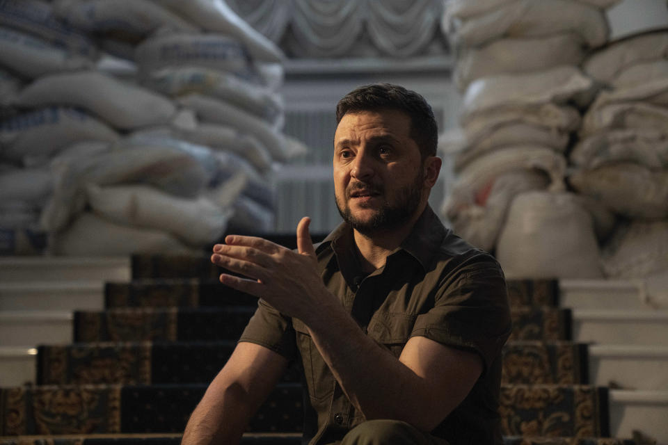 Ukrainian President Volodymyr Zelenskyy speaks during an interview with The Associated Press in his office in Kyiv, Ukraine, Saturday, April 9, 2022. Ukrainian President Volodymyr Zelenskyy says he's committed to pressing for peace despite Russian attacks on civilians that have stunned the world. (AP Photo/Evgeniy Maloletka)