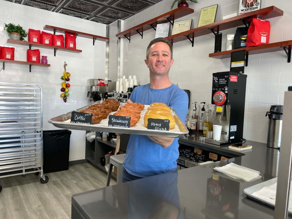 Co-owner Jimmy Wooten offers up a tray of specialty doughnuts at Status Dough Farragut, 10943 Kingston Pike.