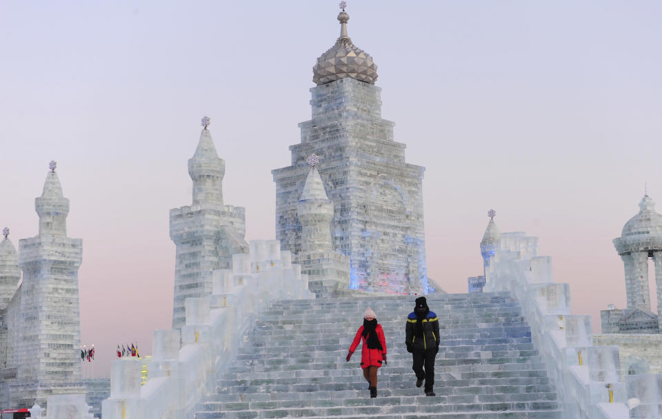 Tourists visit ice sculptures during the testing period of the 13th Harbin Ice and Snow World in Harbin, Heilongjiang province December 25, 2011. The Harbin International Ice and Snow Festival will be officially launched on January 5, 2012. Picture taken December 25, 2011. REUTERS/Sheng Li (CHINA - Tags: ENVIRONMENT ENTERTAINMENT)