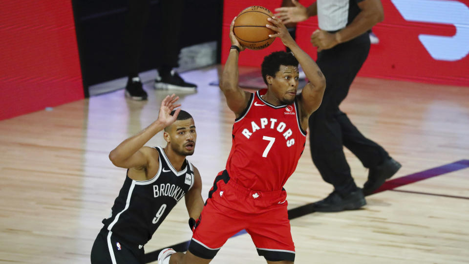 Toronto Raptors guard Kyle Lowry (7) looks to pass while defended by guard Timothe Luwawu-Cabarrot (9) during the second half in Game 3 of an NBA basketball first-round playoff series, Friday, Aug. 21, 2020, in Lake Buena Vista, Fla. (Kim Klement/Pool Photo via AP)