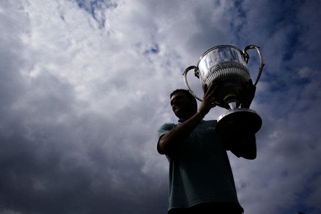 Tommy Paul holds up the trophy after winning the title at Queen's Club