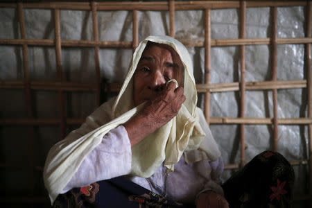 Roshan Begum, a Rohingya refugee, wipes her eyes after hearing the news that her son has been found in Buthidaung prison in Myanmar through trace message request program of Bangladesh Red Crescent Society Bangladesh, at a camp in Cox's Bazar, Bangladesh, July 3, 2018. Picture taken July 3, 2018. REUTERS/Mohammad Ponir Hossain