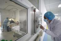 Medical worker calls his colleague inside an isolated ward at Jinyintan Hospital in Wuhan