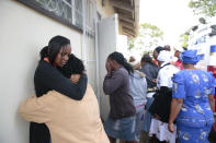 People react after hearing news about their relatives, after a bus crash in Rusape about 170 kilometres east of the capital Harare, Thursday, Nov. 8, 2018. A head-on collision between two buses has killed 47 people, where road accidents are common due to poor roads and bad driving. (AP Photo/Tsvangirayi Mukwazhi)