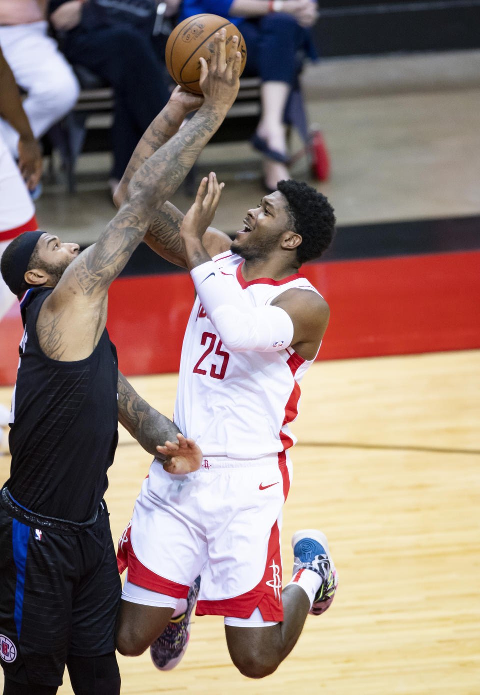 Houston Rockets forward Cameron Oliver (25) shoots over Los Clippers center DeMarcus Cousins (15) during the third quarter of an NBA basketball game Friday, May 14, 2021, in Houston. (Mark Mulligan/Houston Chronicle via AP)