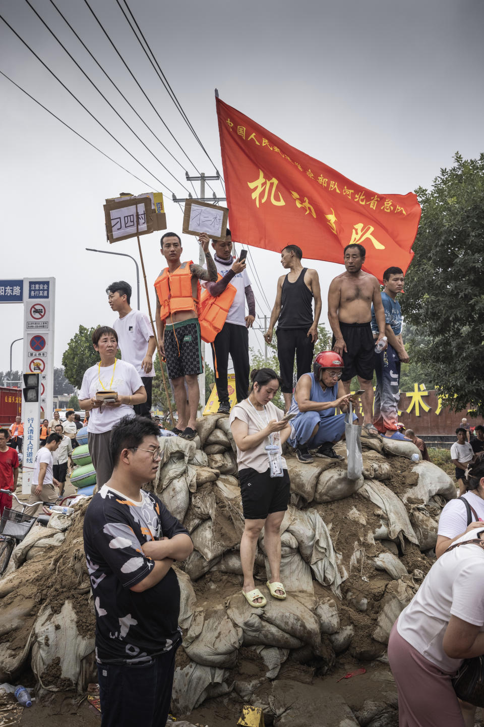 In this photo taken Aug 3, 2023 and released by David Zhang, volunteers help to organise and direct residents to shelters and supplies during floods in Zhuozhou in northern China's Hebei province. Heavy rain and high water levels of China's northeastern rivers are threatening cities downstream, prompting the evacuation of thousands. Hebei province, which surrounds the capital Beijing on three sides, issued alerts for several of its cities. (David Zhang via AP)