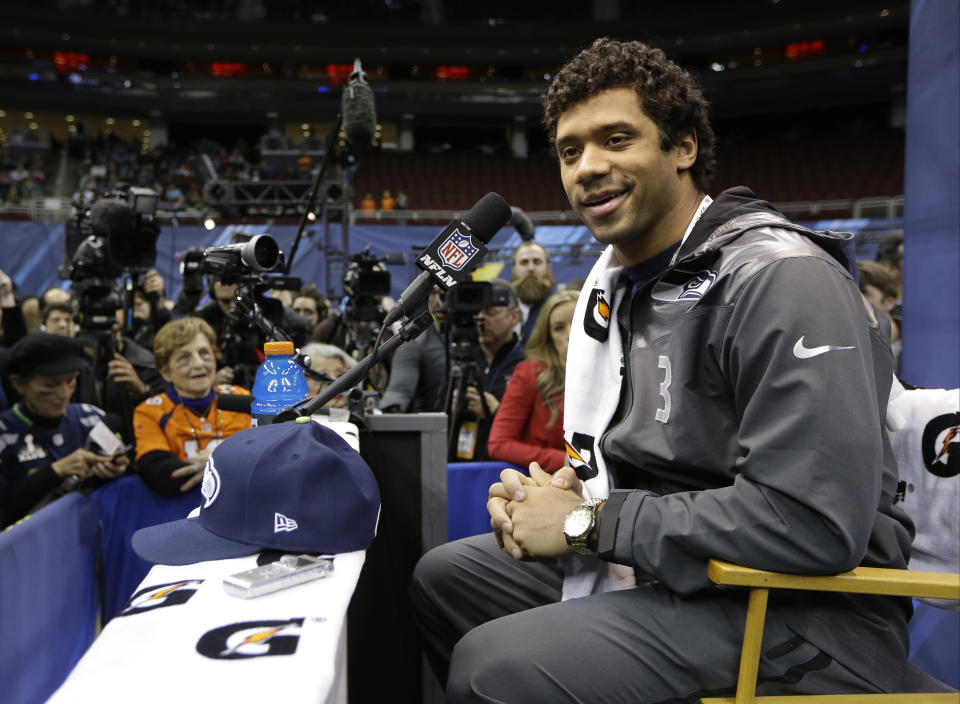 Seattle Seahawks' Russell Wilson answers a question during media day for the NFL Super Bowl XLVIII football game Tuesday, Jan. 28, 2014, in Newark, N.J. (AP Photo/Mark Humphrey)