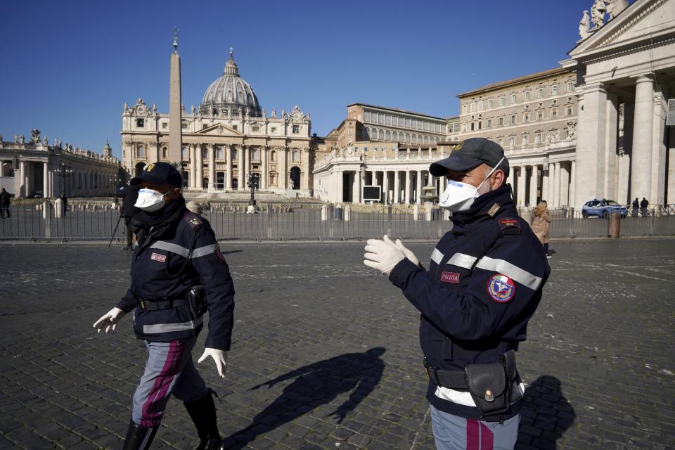 Police officers wearing masks patrol an empty St. Peter's Square at the Vatican, Wednesday, March 11, 2020. Pope Francis held his weekly general audience in the privacy of his library as the Vatican implemented Italy’s drastic coronavirus lockdown measures, barring the general public from St. Peter’s Square and taking precautions to limit the spread of infections in the tiny city state.For most people, the new coronavirus causes only mild or moderate symptoms, such as fever and cough. For some, especially older adults and people with existing health problems, it can cause more severe illness, including pneumonia. (AP Photo/Andrew Medichini)