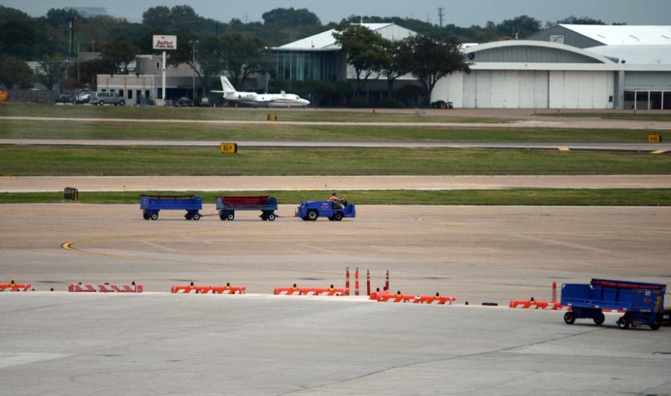 In this photo taken Oct. 29, 2013 in Dallas, four vertical pylons, center, mark the spot where Air Force One parked while at Love Field on Nov. 22, 1963, and is the view from a special window inside the airport's terminal placed especially for showcasing this location. (AP Photo/Benny Snyder)