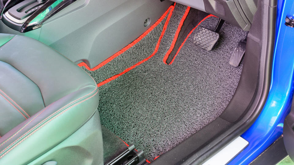 gray vinyl car mat fitting in car.