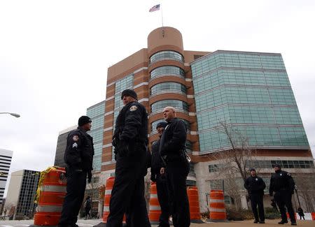 Police officers gather outside the outside Buzz Westfall Justice Center in Clayton, Missouri November 24, 2014. REUTERS/Jim Young