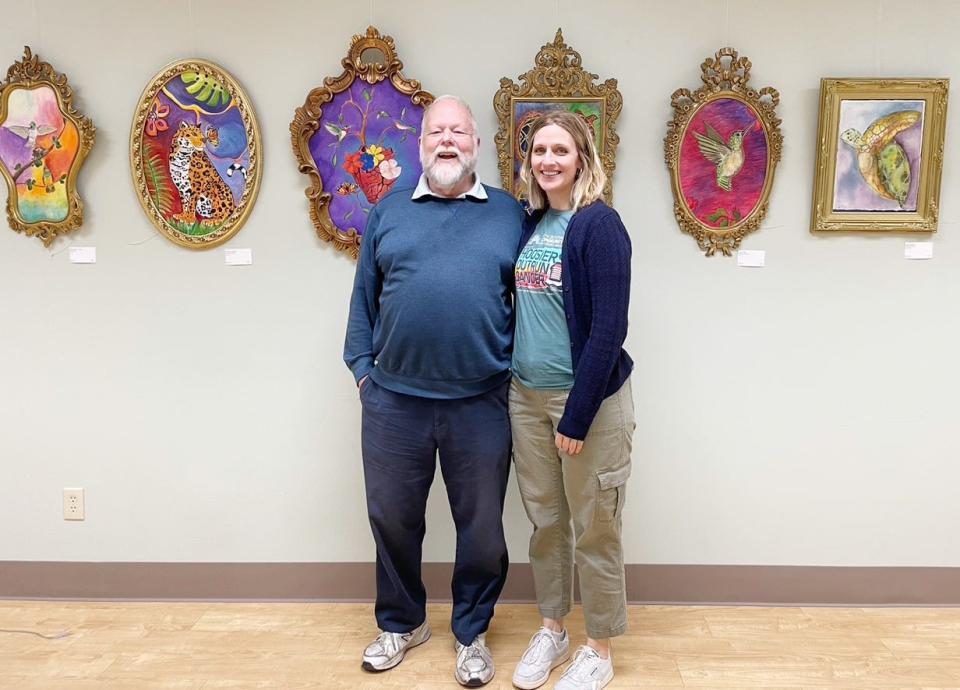 John Andrews-Carrico and Katie Tremel stand in front of some of the artwork created by people who attend art therapy sessions at Cancer Support Community South Central Indiana's Bloomington center. Tremel is program manager at the center; Andrews-Carrico is a participant.