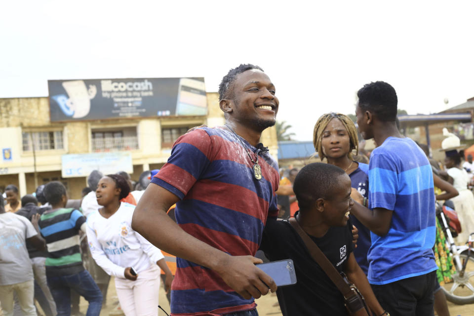 In this photo of Wednesday, Sept.11, 2019, Congolese student and Ebola survivor Claude Mabowa, left, with his friends in Beni Congo. Mabowa managed to pass his college entrance exam while in isolation for treatment. Mabowa, who took them in July behind glass, said this week that this brings him hope he can still realize his dreams. (AP Photo/Al-hadji Kudra Maliro)