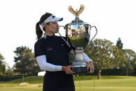 Hannah Green kisses the championship trophy after winning the LPGA's JM Eagle LA Championship golf tournament at Wilshire Country Club, Sunday, April 28, 2024, in Los Angeles. (AP Photo/Ashley Landis)