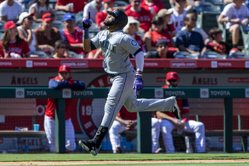 Seattle Mariners' Carlos Santana points skyward while rounding the bases after hitting a grand slam against the Los Angeles Angels during the fifth inning of a baseball game in Anaheim, Calif., Monday, Sept. 19, 2022. (AP Photo/Alex Gallardo)