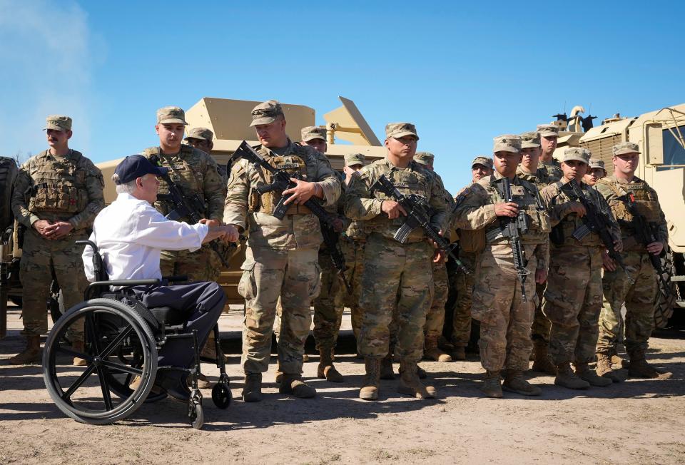 Gov. Greg Abbott greets National Guard troops at a news conference about border policies at Shelby Park in Eagle Pass on Sunday.
