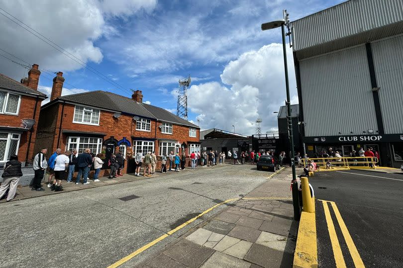 Grimsby Town fans queue for the 2024/25 home kit launch at the Blundell Park club shop