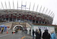 Elderly people wait in line to be vaccinated against COVID-19 at the temporary hospital at the National Stadium in Warsaw, Poland, on Monday, Jan. 25, 2021. Overload of online registration system and reduced deliveries of the Pfizer vaccines are causing delays in the national inoculation procedure that currently aims at vaccinating people aged over 70. (AP Photo/Czarek Sokolowski)