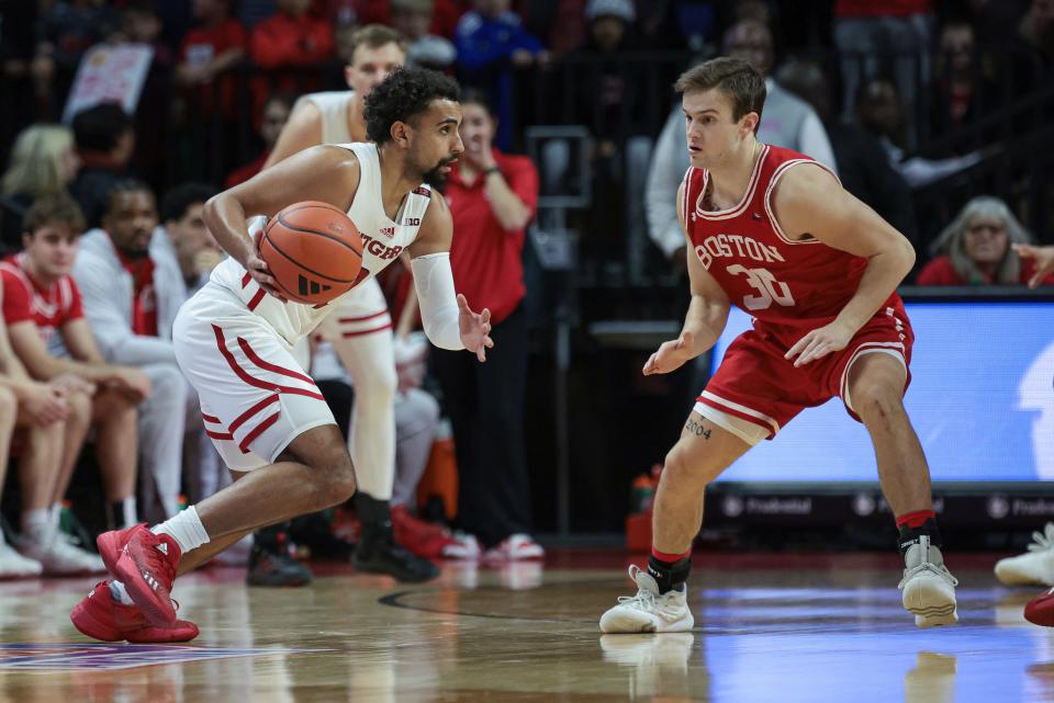 Nov 10, 2023; Piscataway, New Jersey, USA; Rutgers Scarlet Knights guard Noah Fernandes (2) dribbles as Boston University Terriers guard Ben Roy (30) defends during the first half at Jersey Mike's Arena.