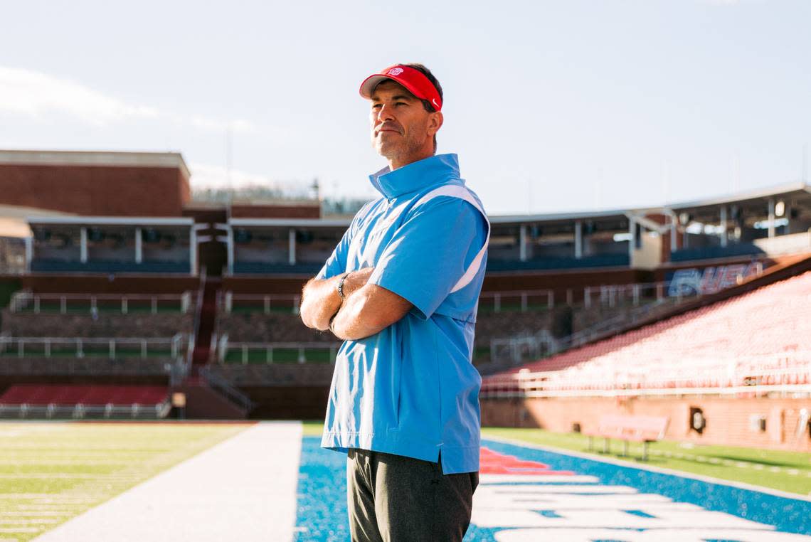 Liberty football coach Jamey Chadwell poses for action shots on the field at Williams Stadium. He left Conway, South Carolina and Coastal Carolina to become the head coach in Lynchburg.